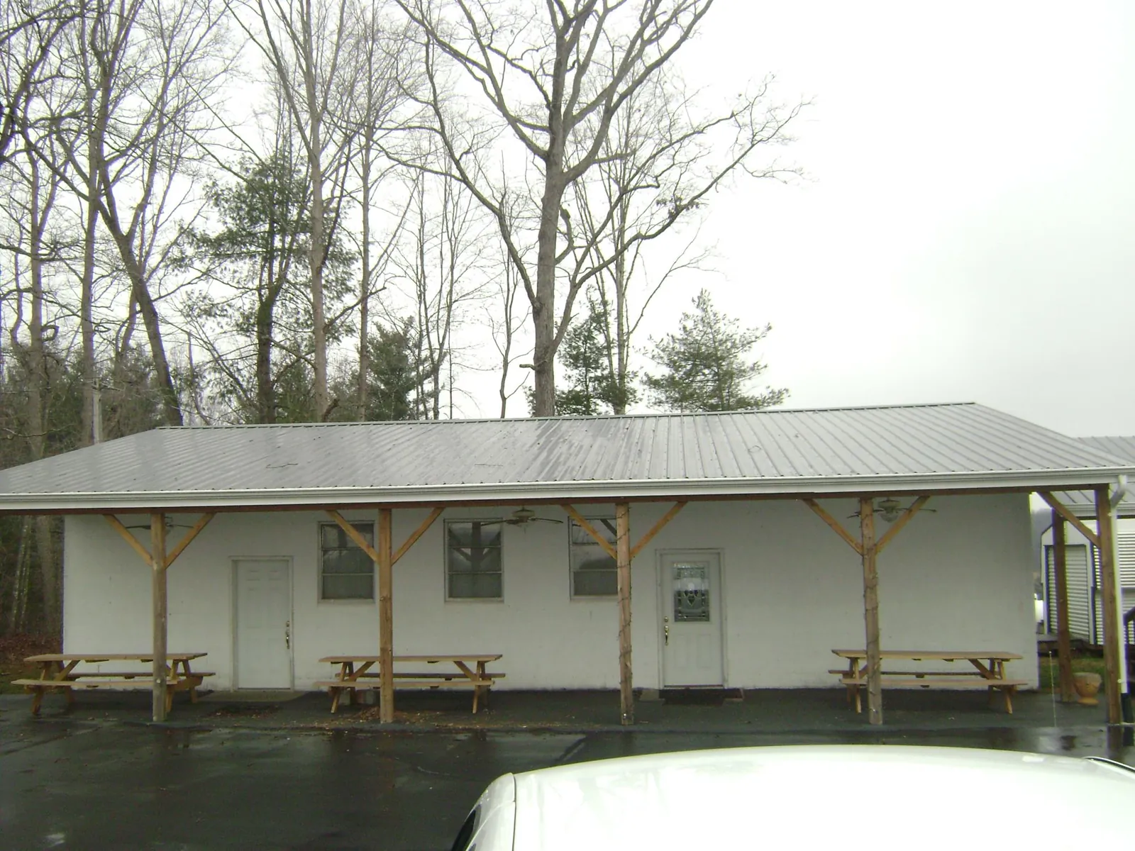 Gray metal roof over a block building with a timber post porch in Klickitat